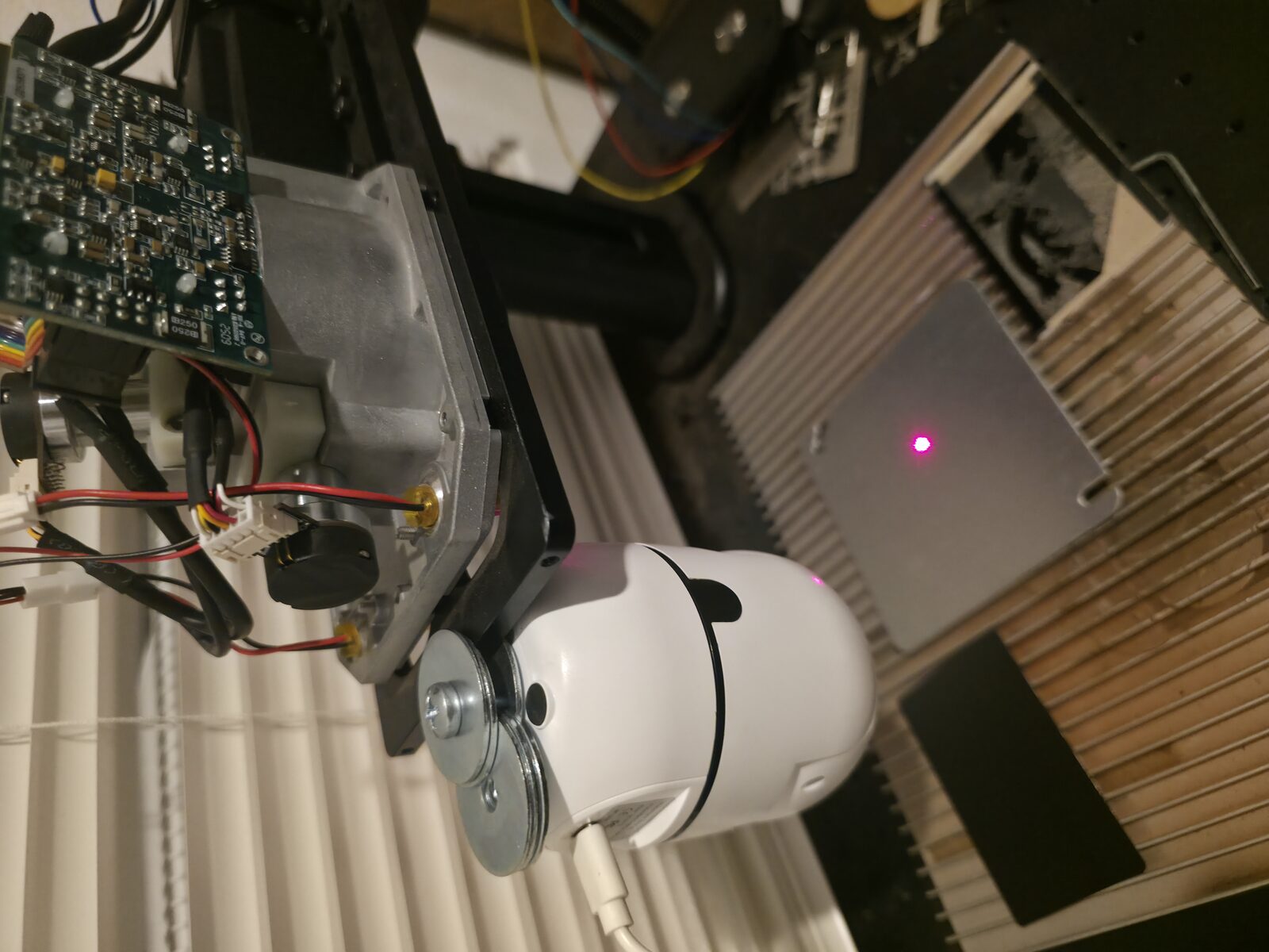MobiCam HDX zip-tied to the ComMarker B4's galvo head, laser alignment dot visible on the work plate below
